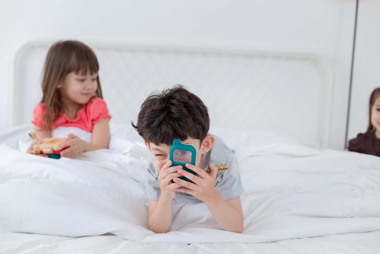 Children role playing with wooden phone
