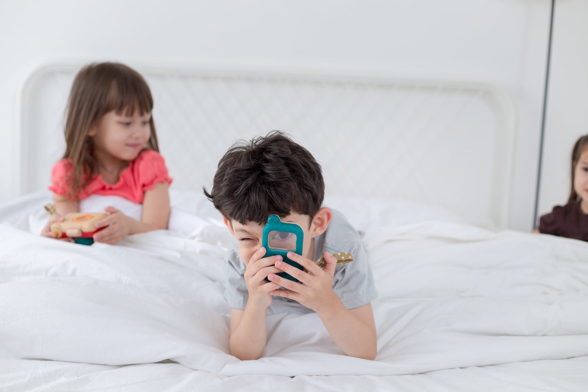 Children role playing with wooden phone