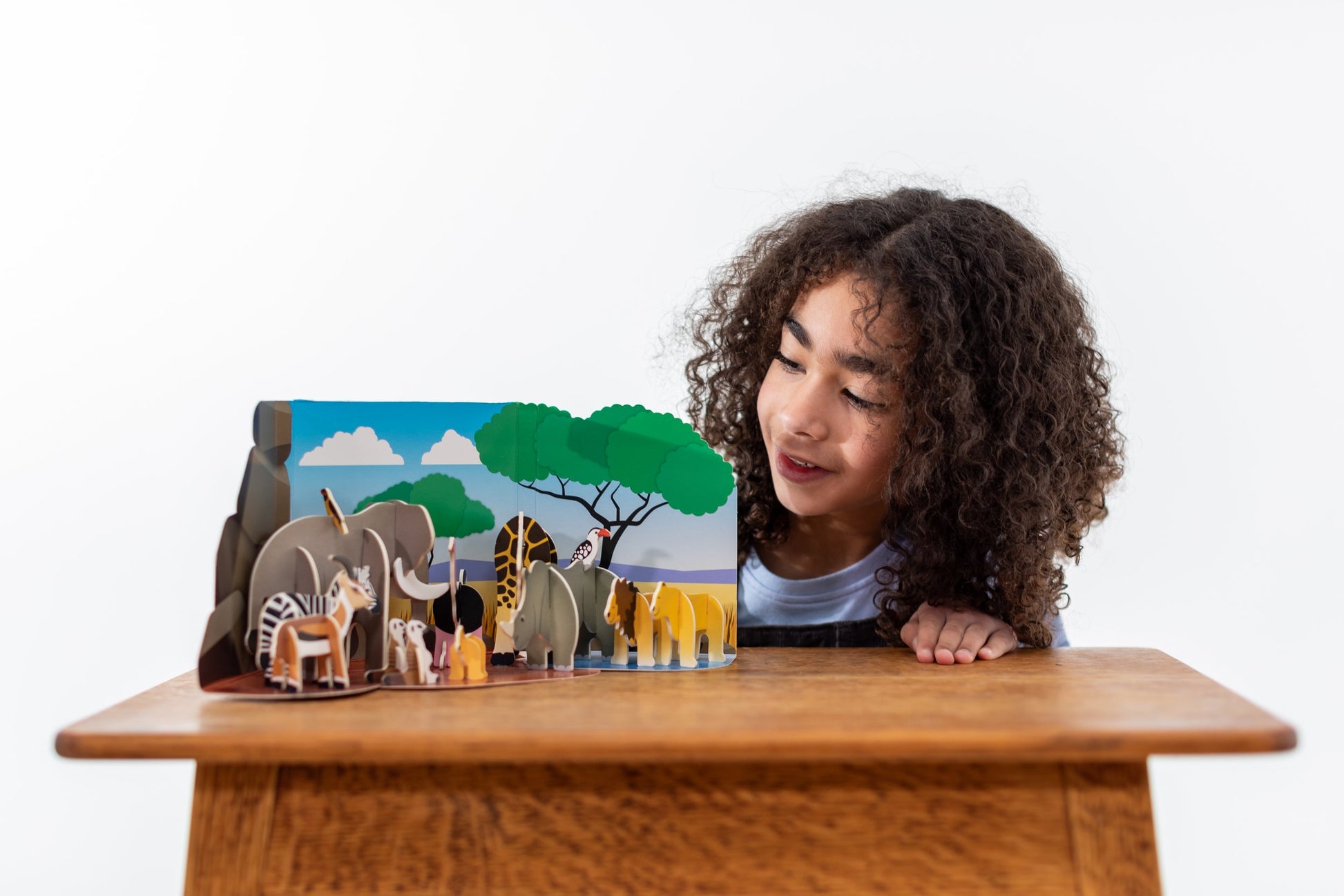 Girl looking at Savannah Animals Playpress Set