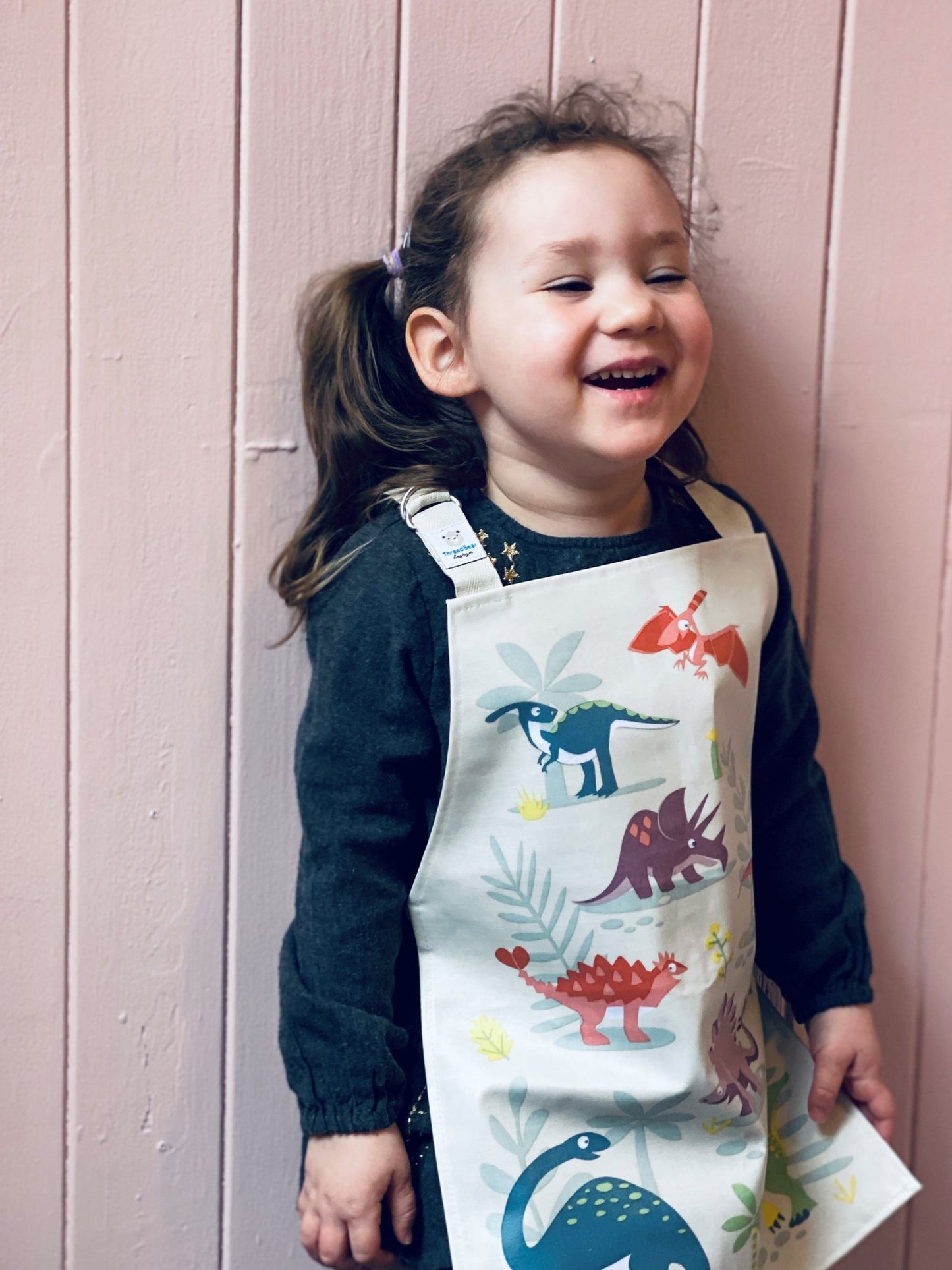 Girl wearing Dinosaur Friends apron