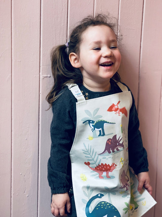 Girl wearing Dinosaur Friends apron