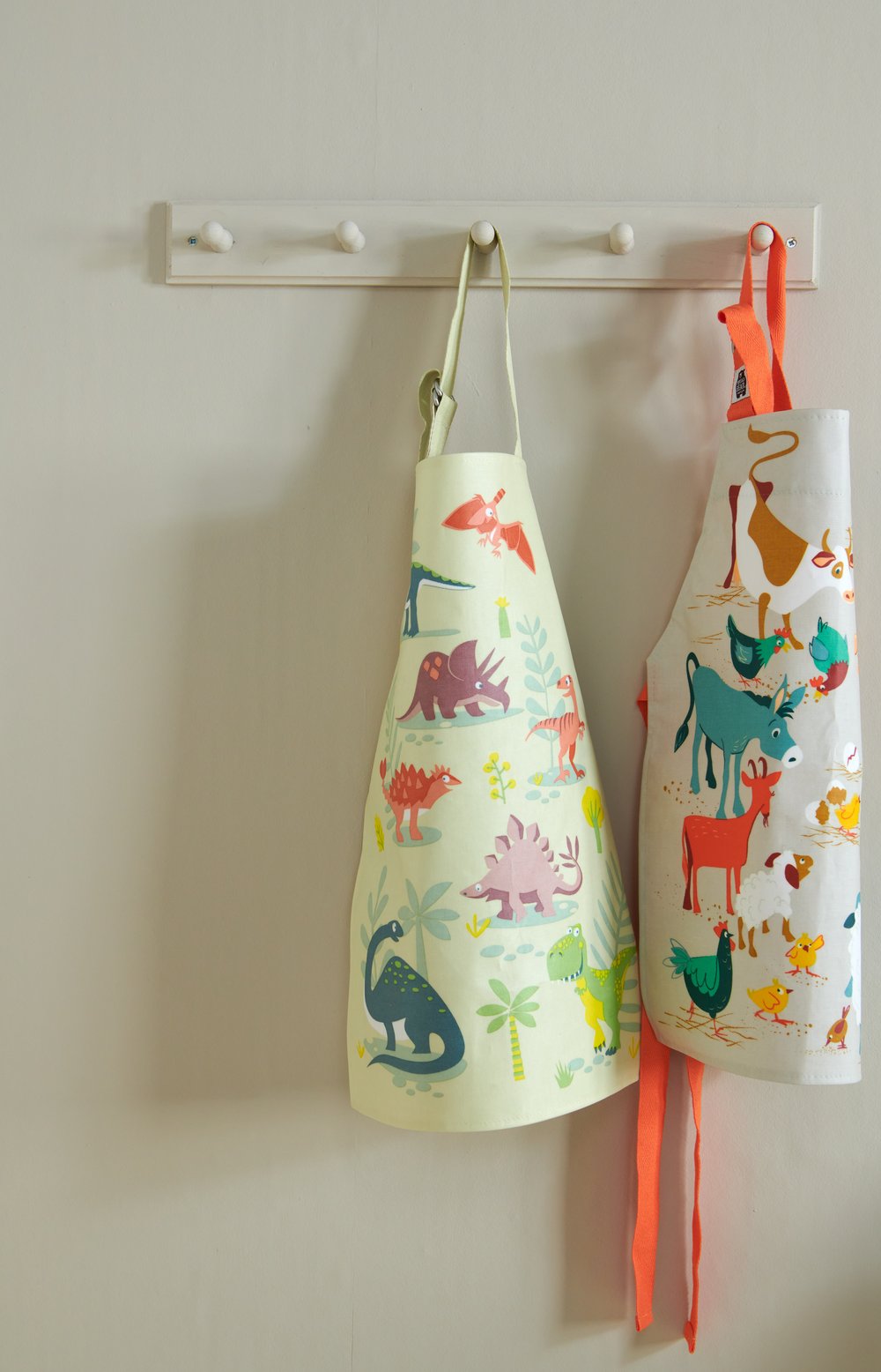 Dinosaur Friends aprons hanging up