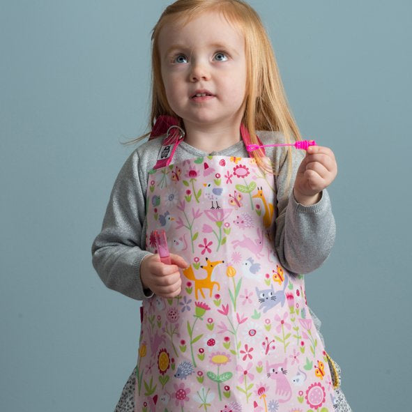 Girl wearing Flora's Garden apron