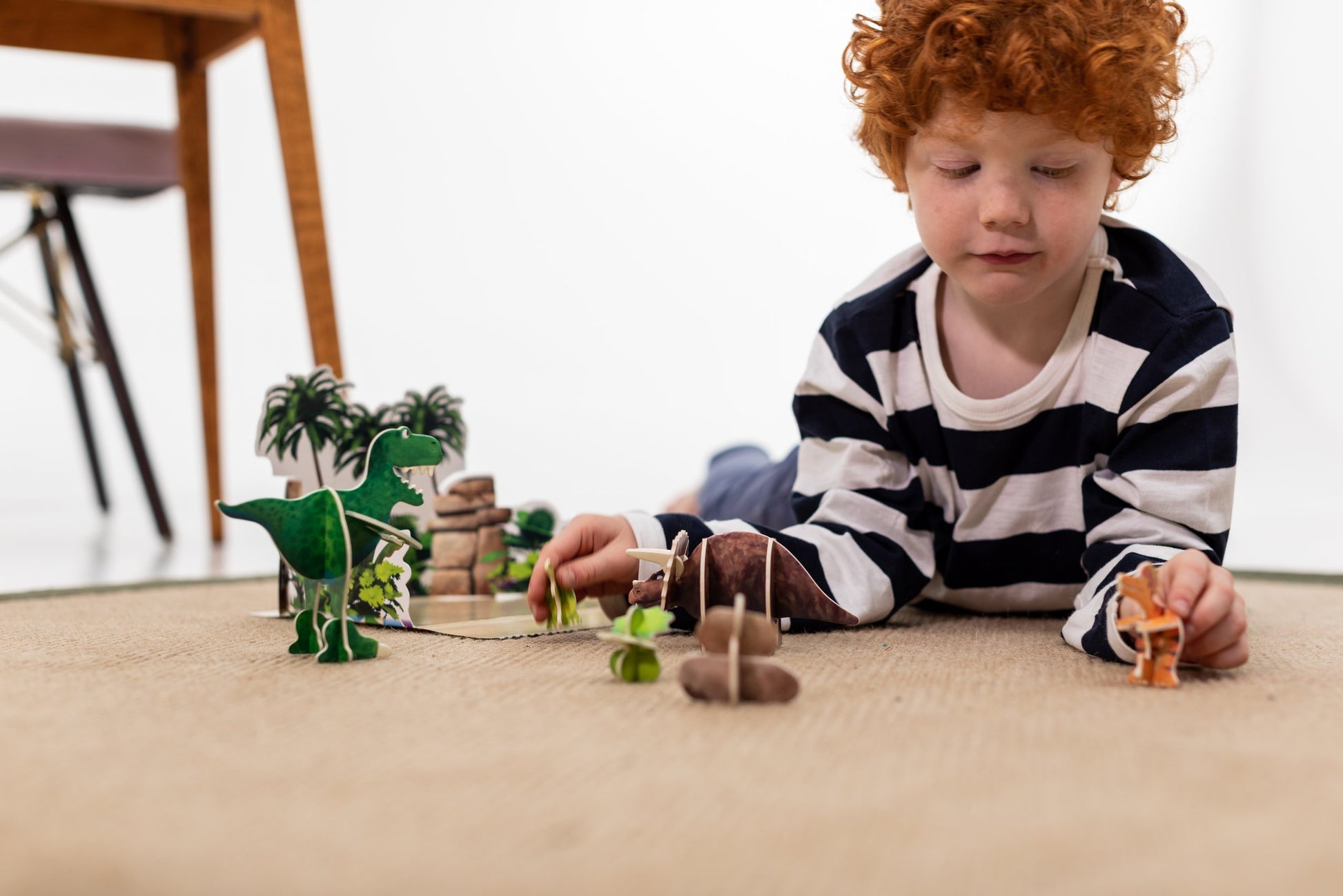 Child playing with Dinosaur Roar playpress set on floor