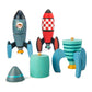 One deconstructed rocket ship in the foreground with two constructed rocket ships in the background
