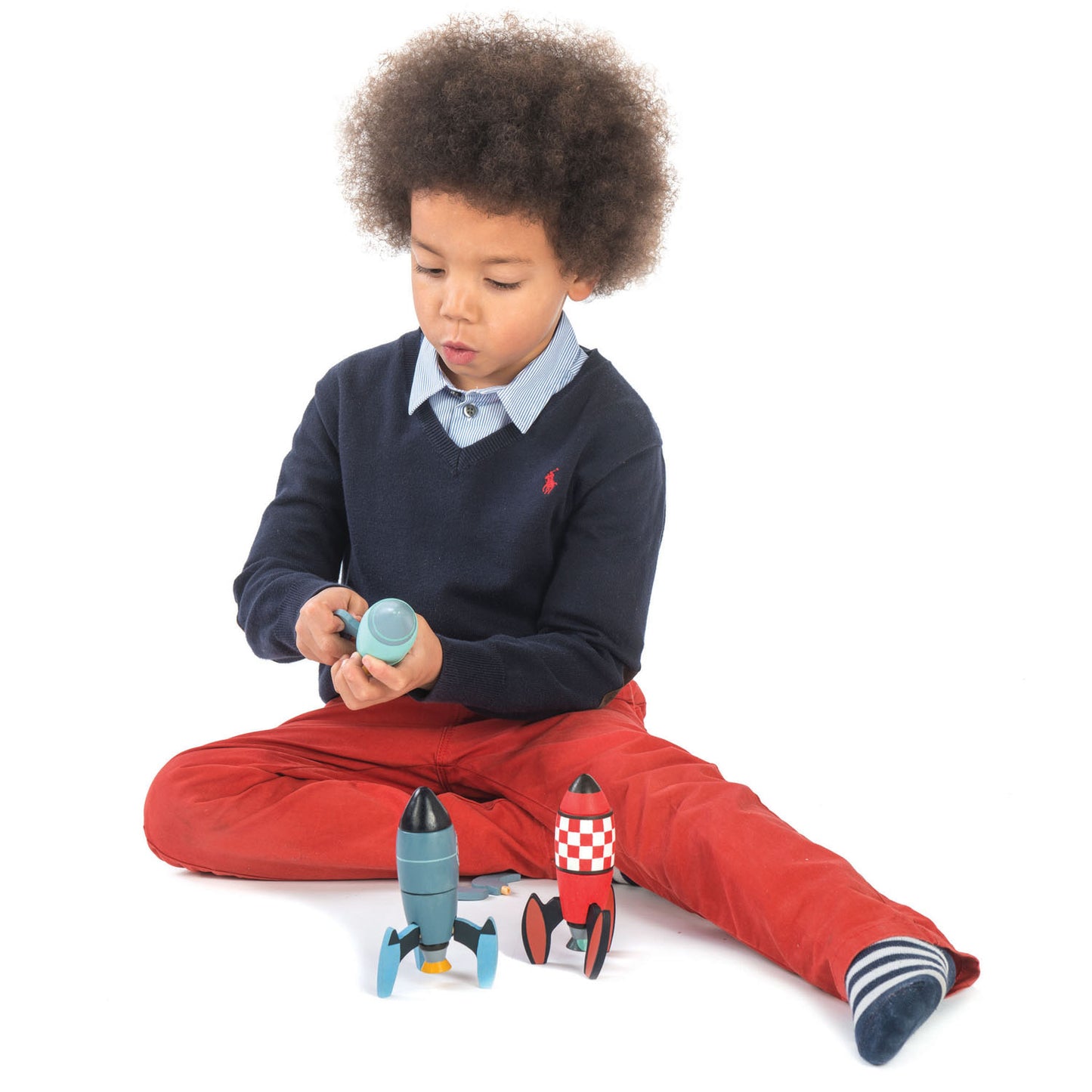 Boy constructing wooden rocket ship