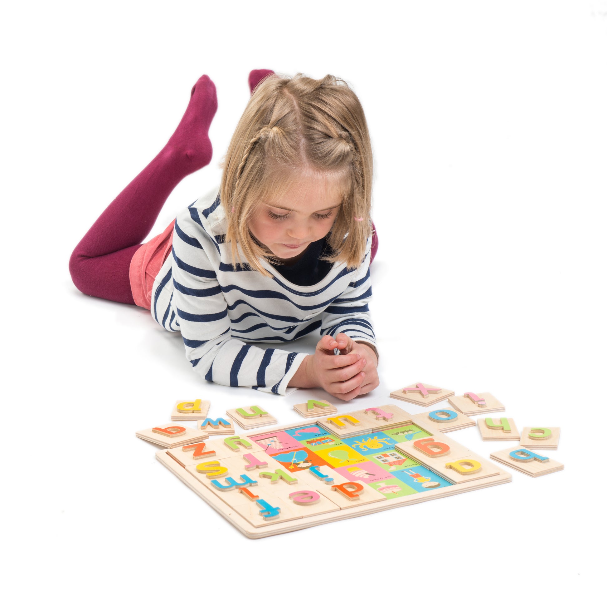 Girl building wooden alphabet puzzle