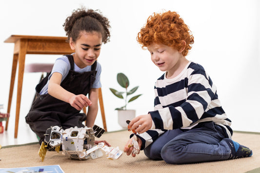 Boy and girl playing with Space Station Playpress set together